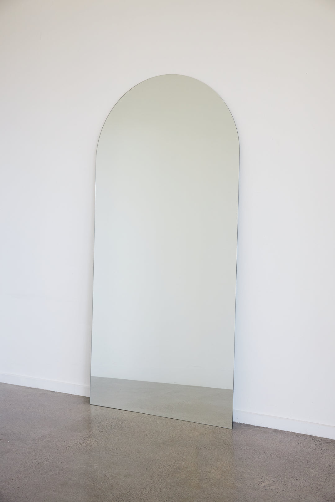 Frameless arch mirror